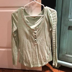 mint colored long-sleeve t-shirt with sleeve decal